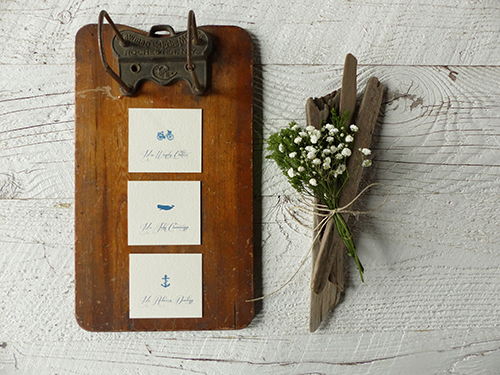 Escort cards with beach themed icons  for a preppy-rustic Cape Cod wedding by Shindig Bespoke