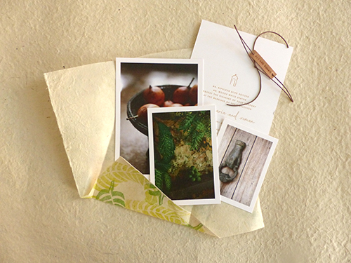 Invitation for Cartagena, Columbia wedding with hand stamped banana leaves on lokta paper with leather name tag by Shindig Bespoke